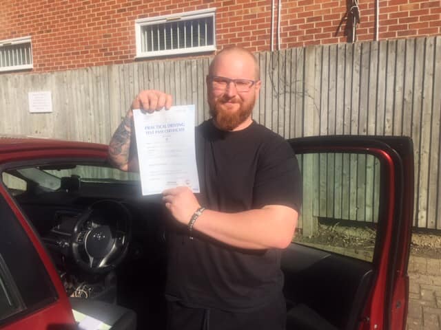 Man holding practical driving test certificate