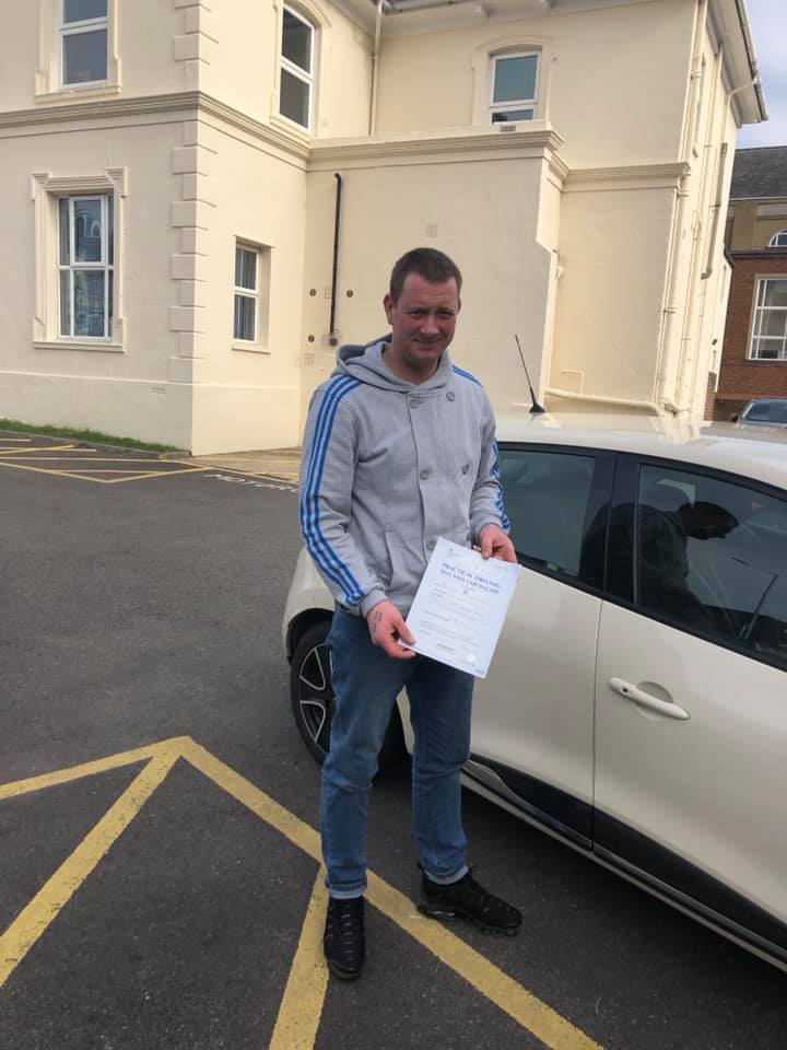 Man holding driving test certificate
